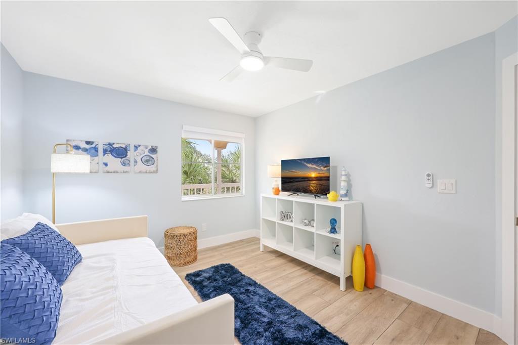 2711 Citrus Lake Drive, Unit F305 Naples, FL 34109 - Photo 32 of 50 a bedroom with furniture and a flat screen tv