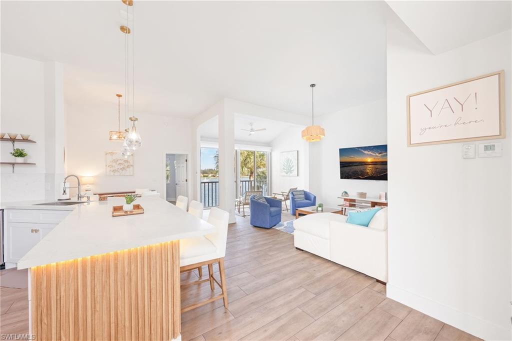 2711 Citrus Lake Drive, Unit F305 Naples, FL 34109 - Photo 6 of 50 a living room with furniture and a flat screen tv