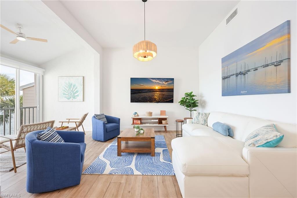 2711 Citrus Lake Drive, Unit F305 Naples, FL 34109 - Photo 7 of 50 a living room with furniture and a flat screen tv