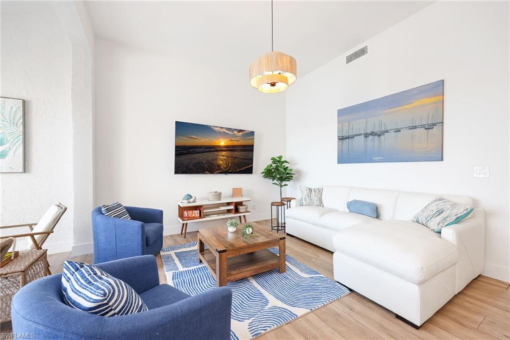 2711 Citrus Lake Drive, Unit F305 Naples, FL 34109 - Photo 8 of 50 a living room with furniture and a flat screen tv