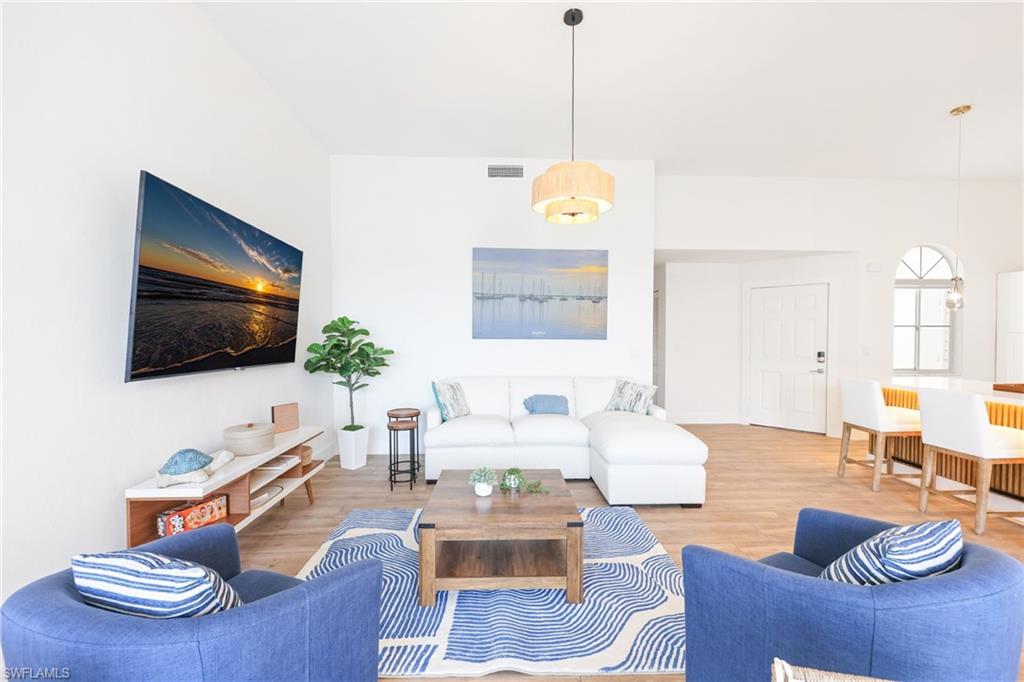 2711 Citrus Lake Drive, Unit F305 Naples, FL 34109 - Photo 9 of 50 a living room with furniture and a flat screen tv