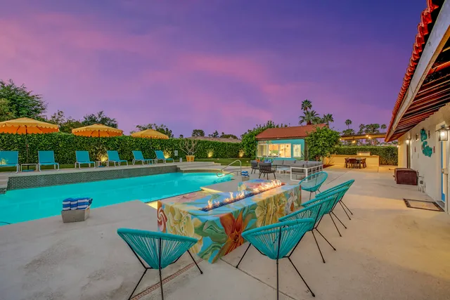 a kitchen with stainless steel appliances granite countertop a stove top oven a sink dishwasher a refrigerator and white cabinets with wooden floor