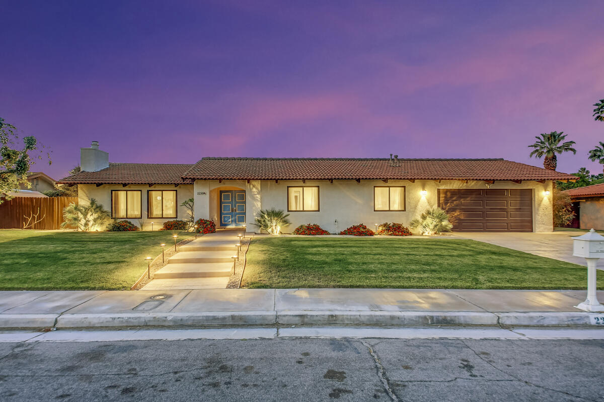 2230 Tamarisk Road Palm Springs, CA 92262 - Photo 2 of 66 a front view of a house with a yard and a garage