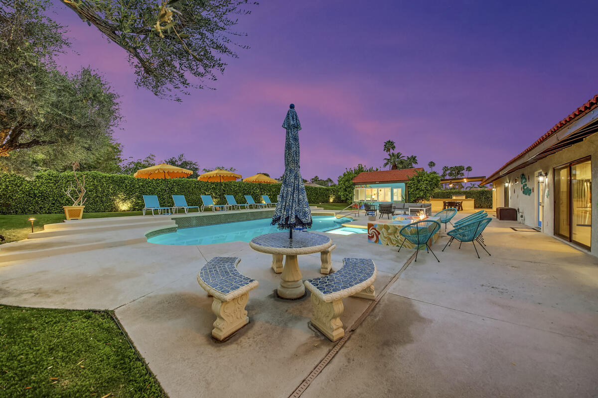 2230 Tamarisk Road Palm Springs, CA 92262 - Photo 21 of 66 a view of a patio with chairs and a fire pit