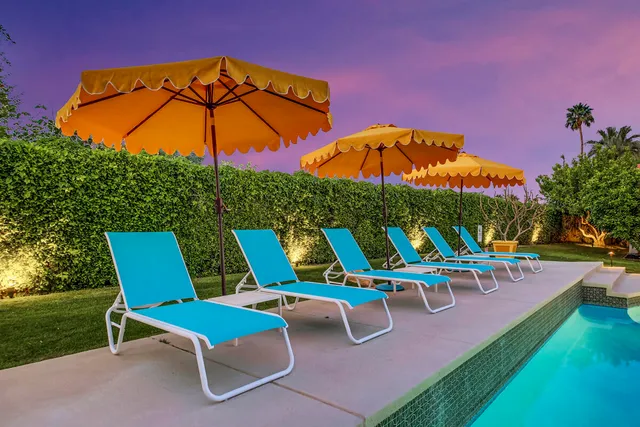 a bathroom with a granite countertop toilet sink and mirror