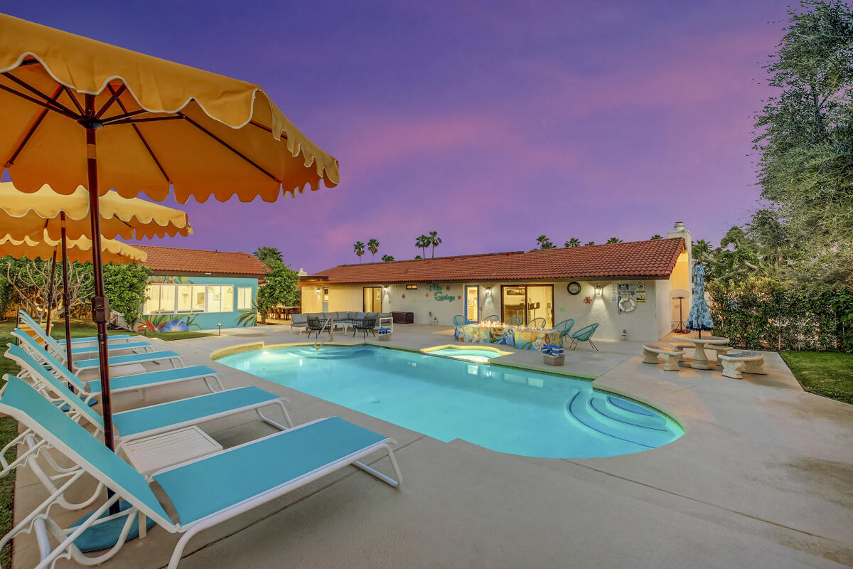2230 Tamarisk Road Palm Springs, CA 92262 - Photo 25 of 66 a view of a backyard with a patio and fire pit