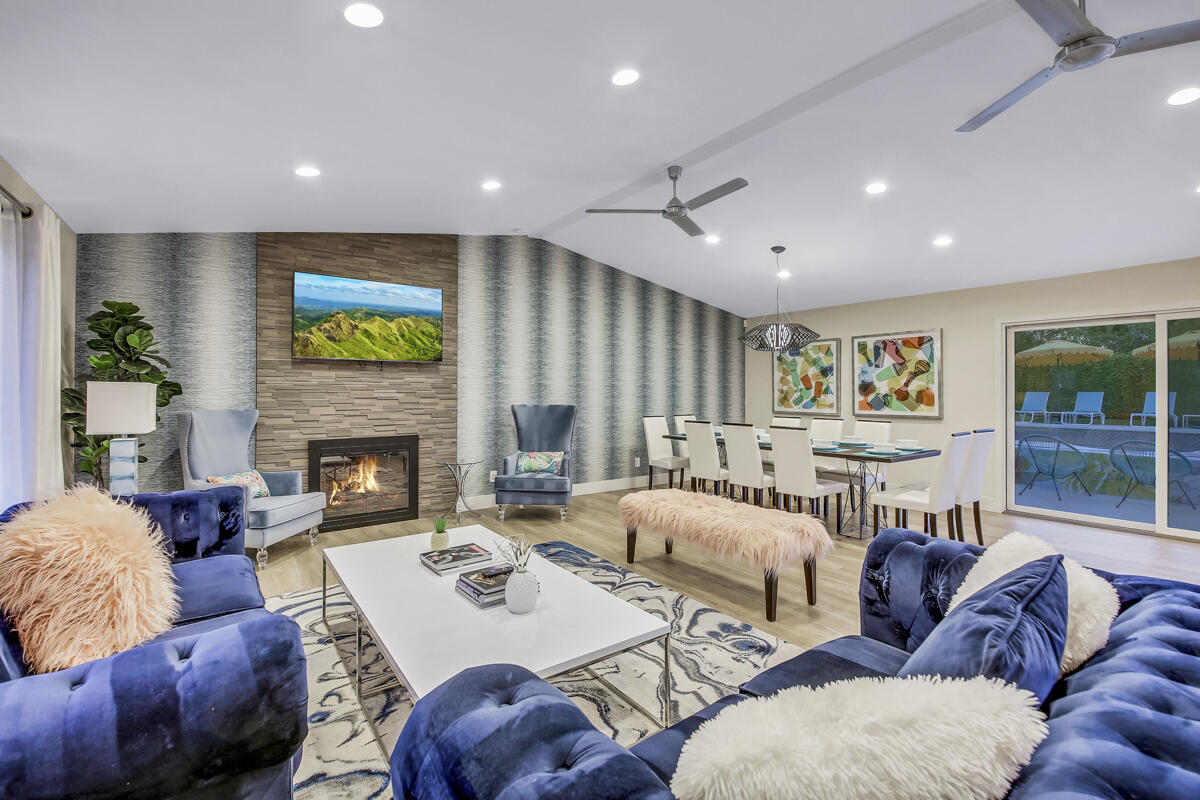 2230 Tamarisk Road Palm Springs, CA 92262 - Photo 32 of 66 a living room with furniture and a fireplace