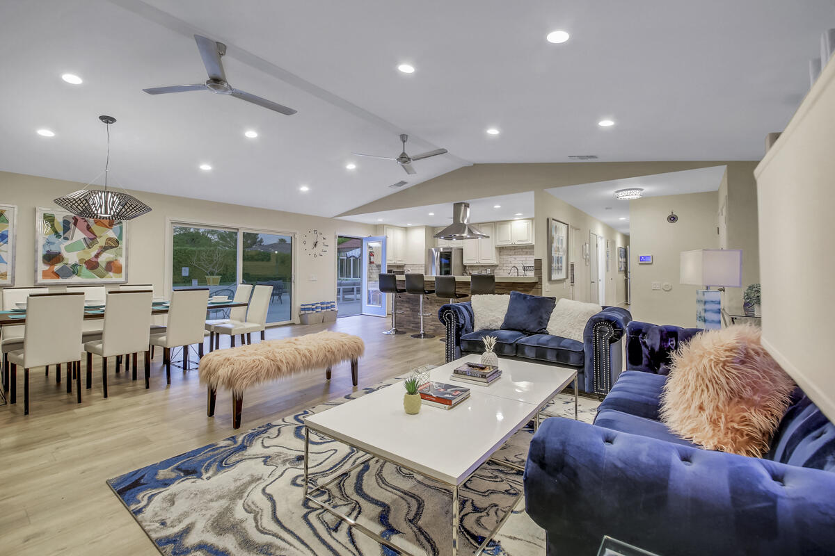 2230 Tamarisk Road Palm Springs, CA 92262 - Photo 33 of 66 a living room with furniture and a dining table with kitchen view