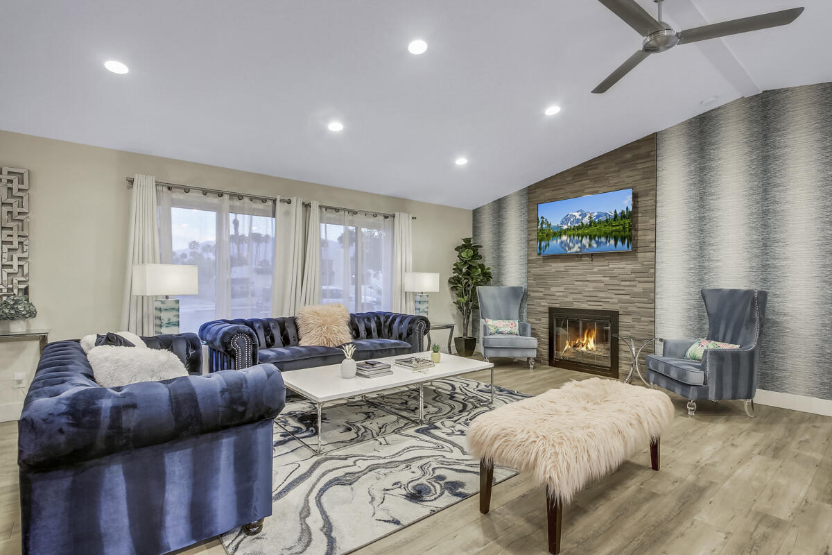 2230 Tamarisk Road Palm Springs, CA 92262 - Photo 35 of 66 a living room with furniture and a fireplace
