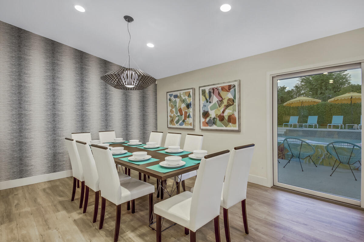 2230 Tamarisk Road Palm Springs, CA 92262 - Photo 37 of 66 a view of a dining room with furniture window and wooden floor