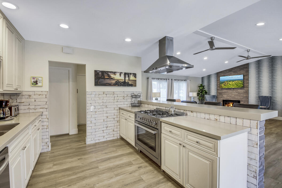 2230 Tamarisk Road Palm Springs, CA 92262 - Photo 40 of 66 a kitchen with stainless steel appliances granite countertop a stove and a sink
