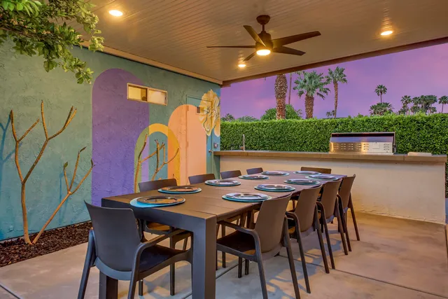 a dinning table and chairs in patio of a house