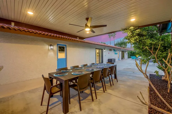 a view of a dinning table and chairs in the patio