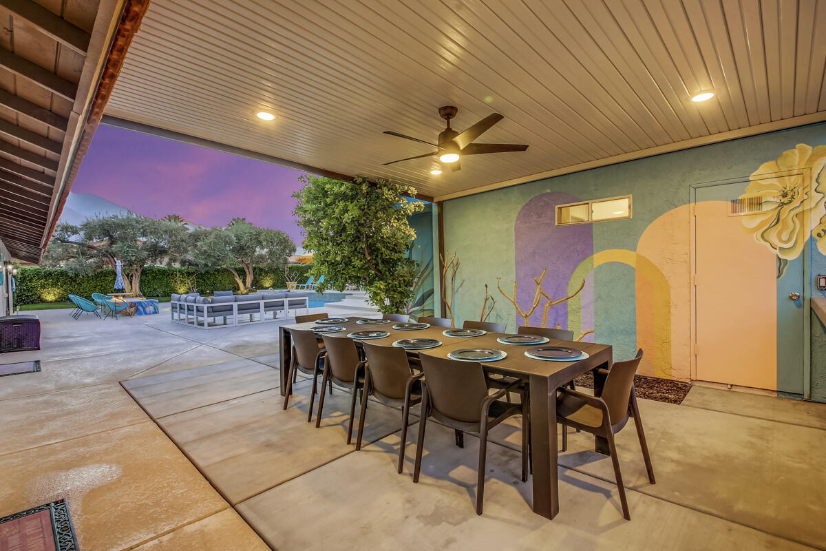 2230 Tamarisk Road Palm Springs, CA 92262 - Photo 7 of 66 a view of a dinning table and chairs in the patio
