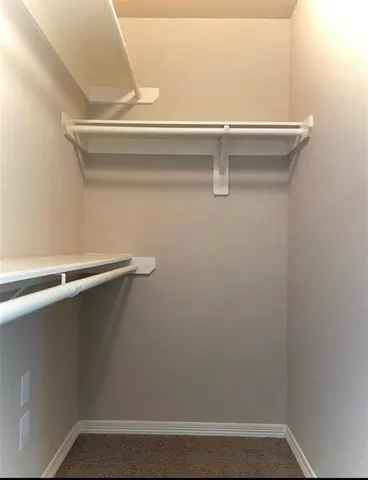 a view of an empty room with a ceiling fan