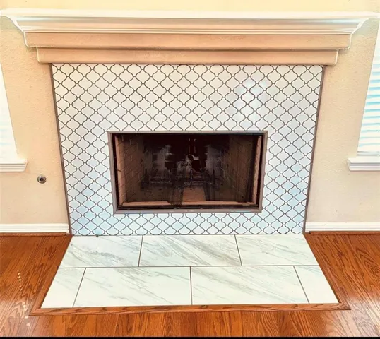 a view of a kitchen with a sink and a fireplace