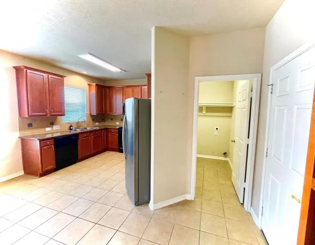 a view of a livingroom with furniture and chandelier fan