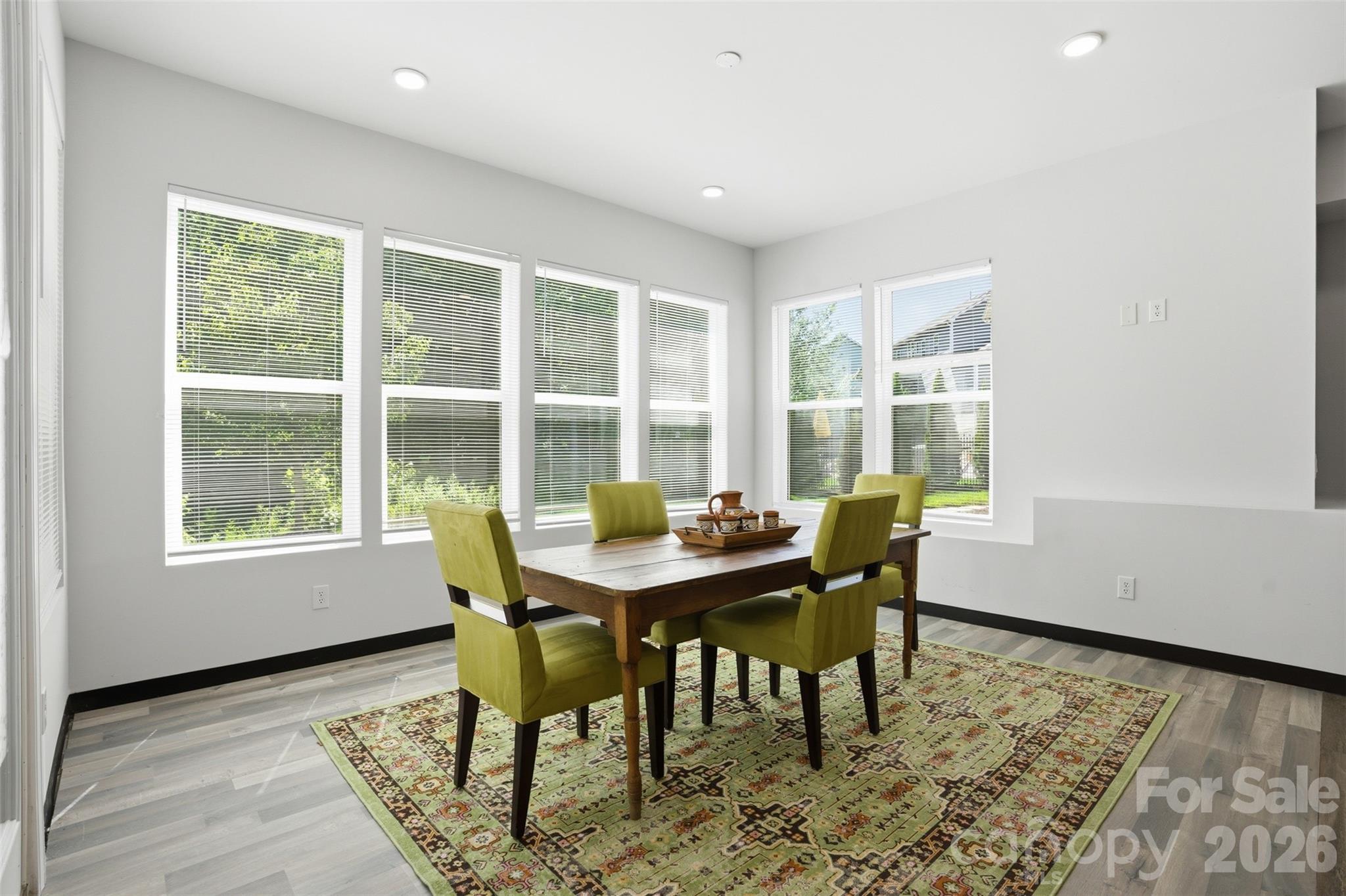 14022 Salem Ridge Road Huntersville, NC 28078 - Photo 29 of 38 a view of a dining room with furniture a rug and wooden floor