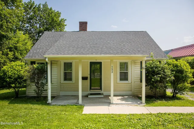 an empty room with windows and fireplace