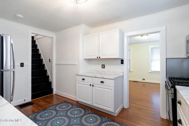 a view of kitchen with refrigerator and window