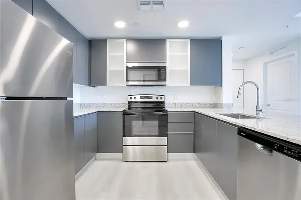 a kitchen with a sink and stainless steel appliances