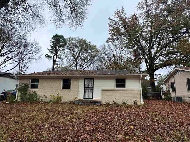 a front view of house with yard and trees