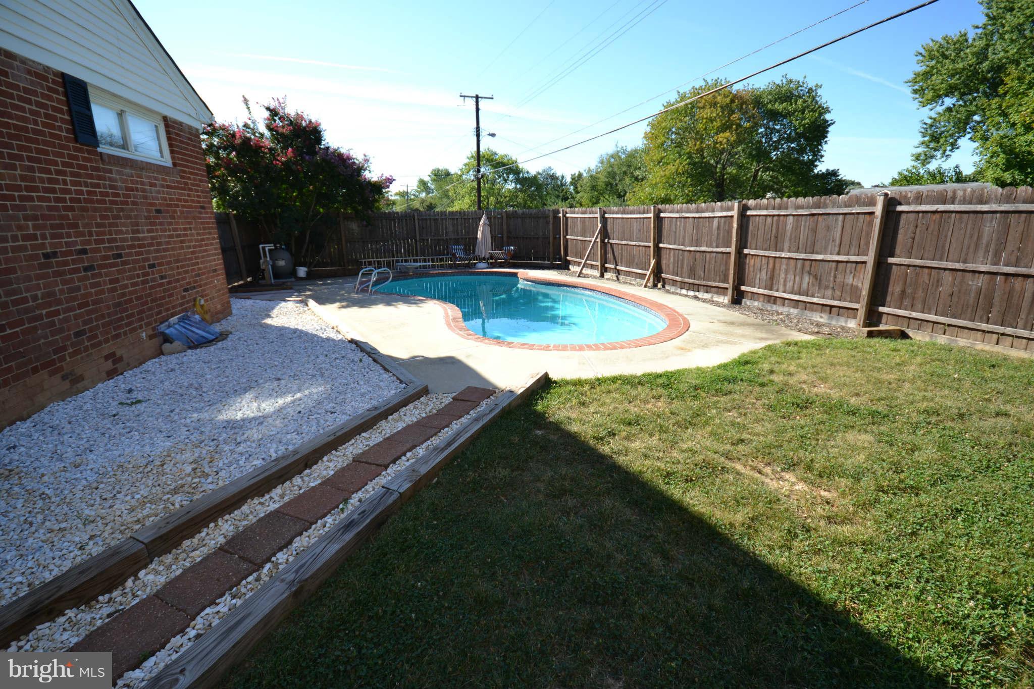 423 Belton Road Silver Spring, MD 20901 - Photo 11 of 28 a view of a backyard with a chair and potted plants