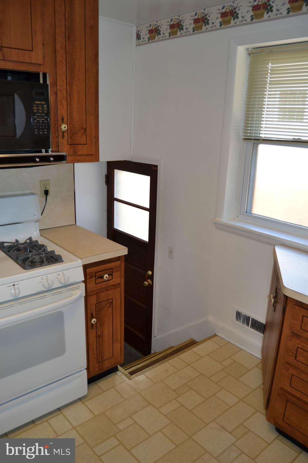 423 Belton Road Silver Spring, MD 20901 - Photo 16 of 28 a kitchen with a stove a sink and a microwave