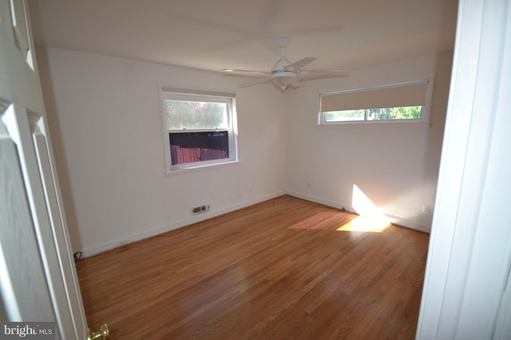 423 Belton Road Silver Spring, MD 20901 - Photo 20 of 28 an empty room with wooden floor and windows