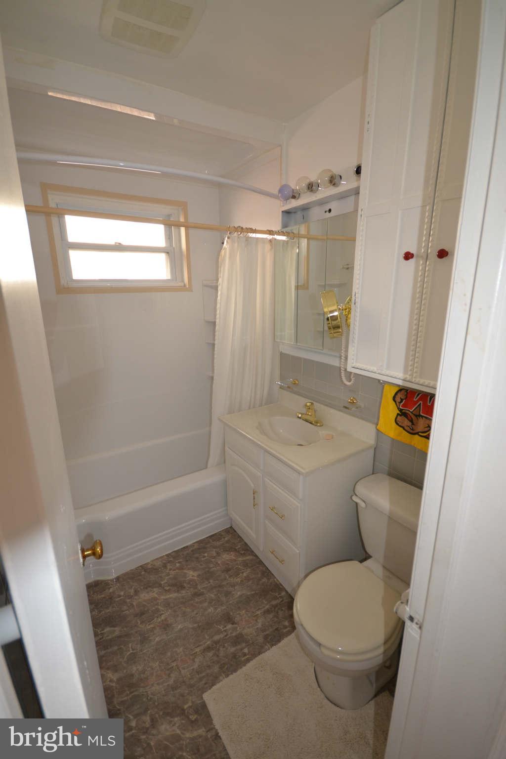 423 Belton Road Silver Spring, MD 20901 - Photo 21 of 28 a bathroom with a granite countertop toilet a sink and a bathtub