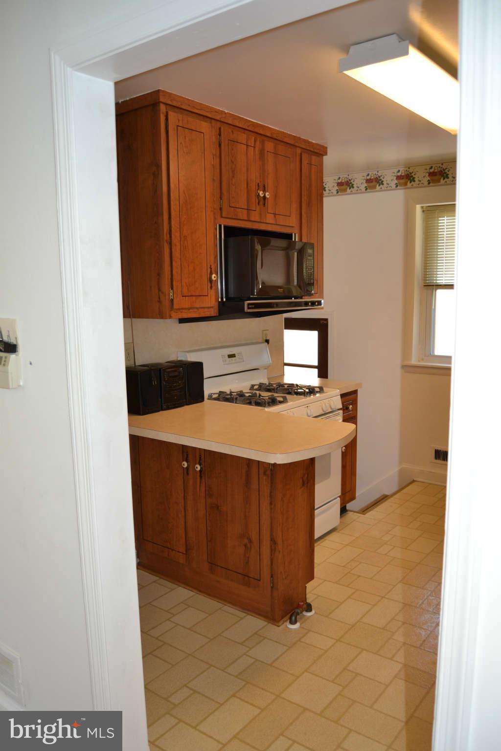 423 Belton Road Silver Spring, MD 20901 - Photo 4 of 28 a kitchen with stainless steel appliances granite countertop a sink stove and microwave