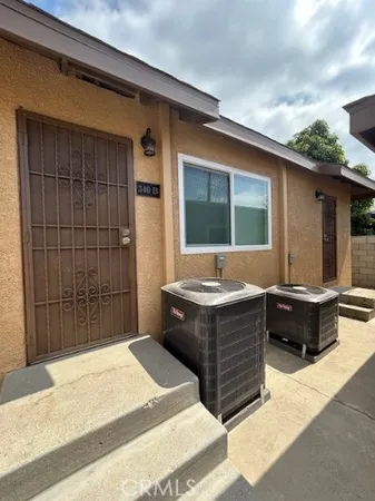 a front view of house with barbeque grill