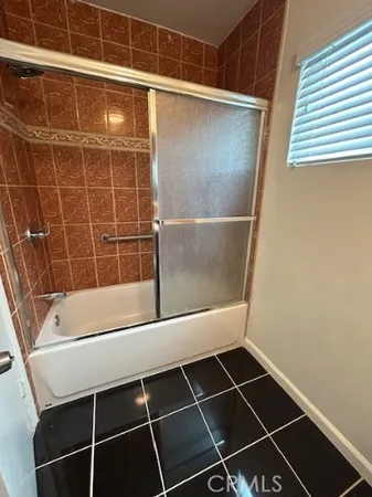 a bathroom with a shower and a sink