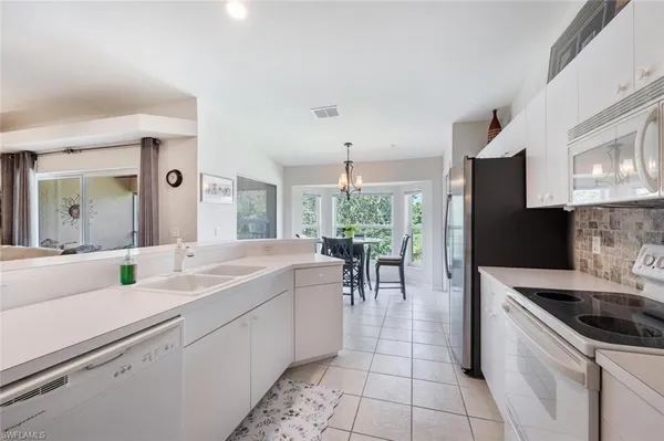 a kitchen with a sink stove and cabinets