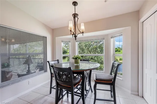 a dining room with furniture a chandelier and wooden floor