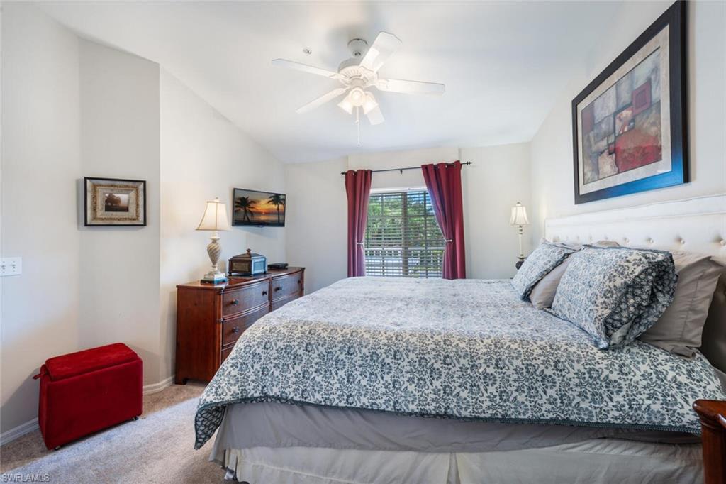 2895 Cypress Trace Circle, Unit 202 Naples, FL 34119 - Photo 17 of 30 a bedroom with a bed and dresser
