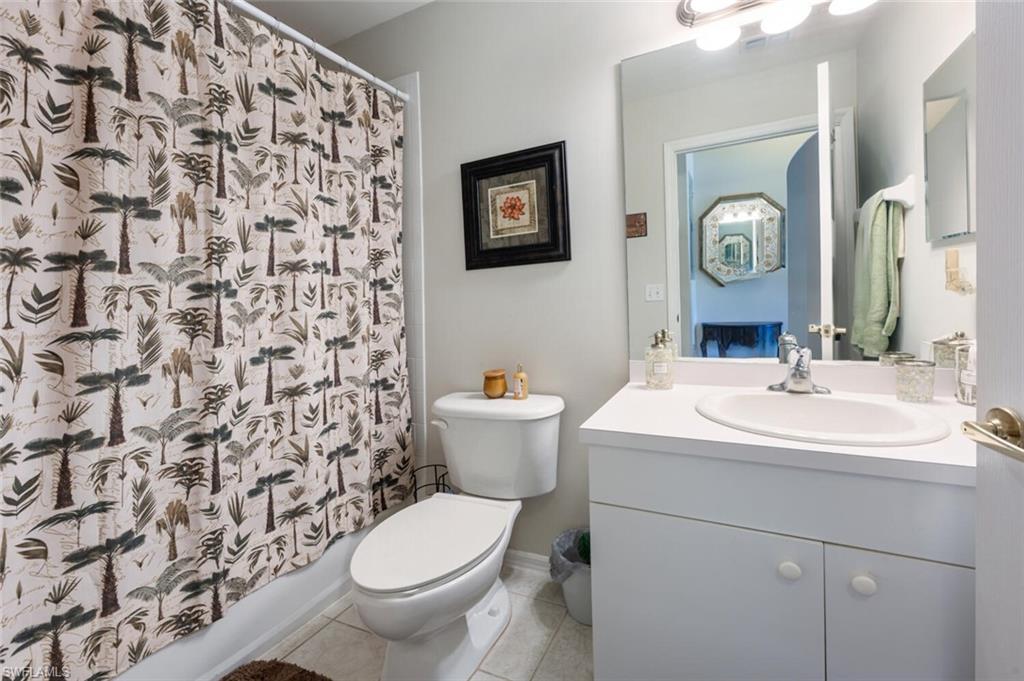 2895 Cypress Trace Circle, Unit 202 Naples, FL 34119 - Photo 21 of 30 a bathroom with a sink and a mirror