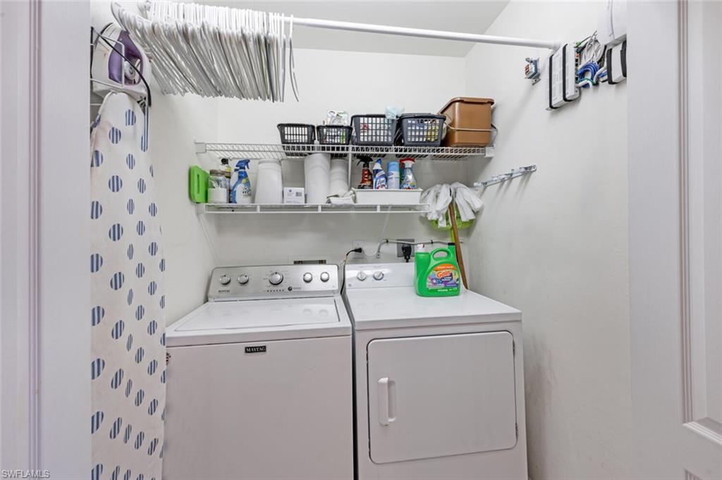 2895 Cypress Trace Circle, Unit 202 Naples, FL 34119 - Photo 22 of 30 a utility room with dryer and washer