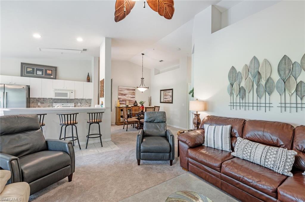2895 Cypress Trace Circle, Unit 202 Naples, FL 34119 - Photo 7 of 30 a living room with furniture and a large window