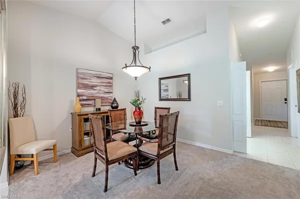 a dining room with furniture and window