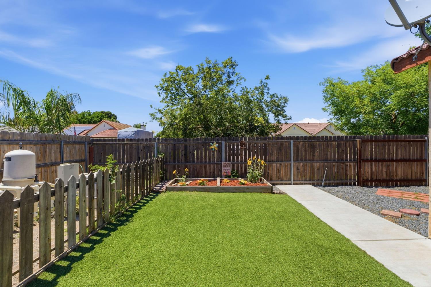 1757 Homestead Way Lemoore, CA 93245 - Photo 28 of 35 a view of a backyard with wooden fence and a slide