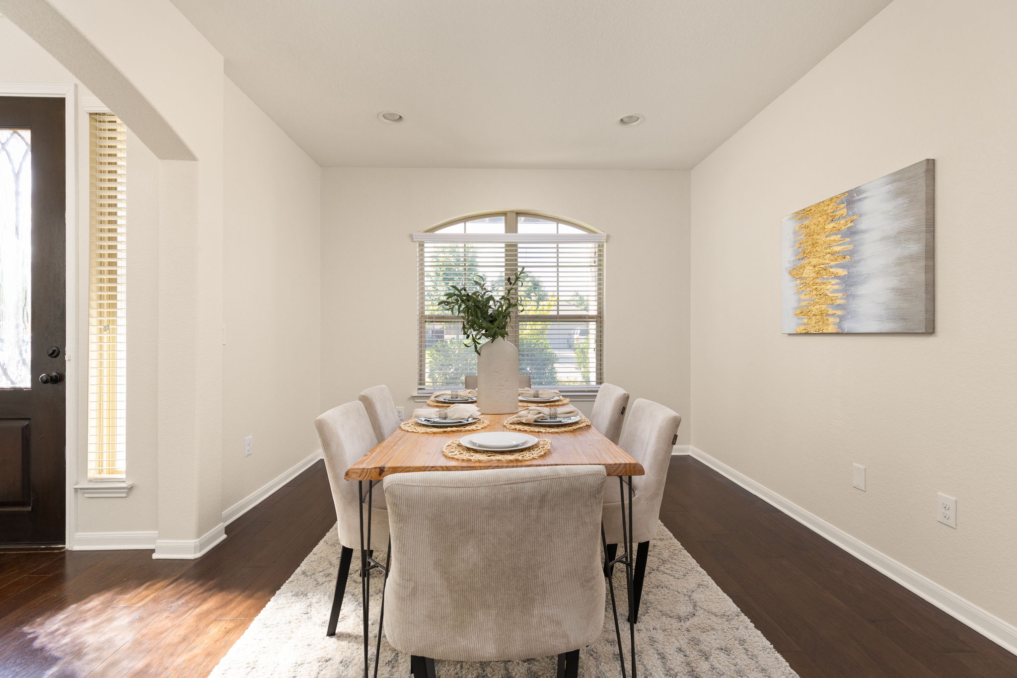 2400 Leonards Pass Leander, TX 78641 - Photo 6 of 40 Elegant hardwood flooring enhances this dining room, perfect for entertaining guests.