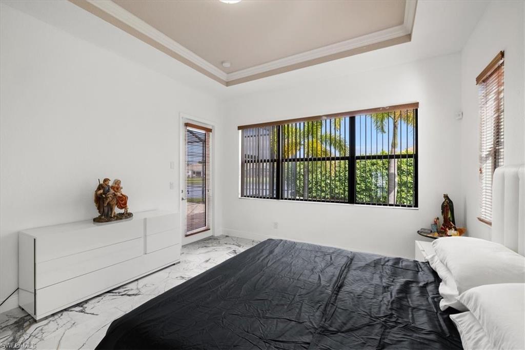 1509 Serrano Circle Naples, FL 34105 - Photo 12 of 24 a bedroom with a bed and window