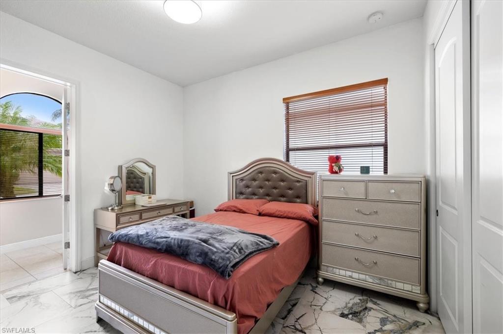 1509 Serrano Circle Naples, FL 34105 - Photo 15 of 24 a bedroom with a bed and a dresser
