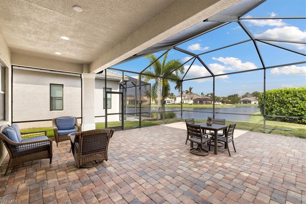 1509 Serrano Circle Naples, FL 34105 - Photo 19 of 24 a view of a patio with a dining table and chairs