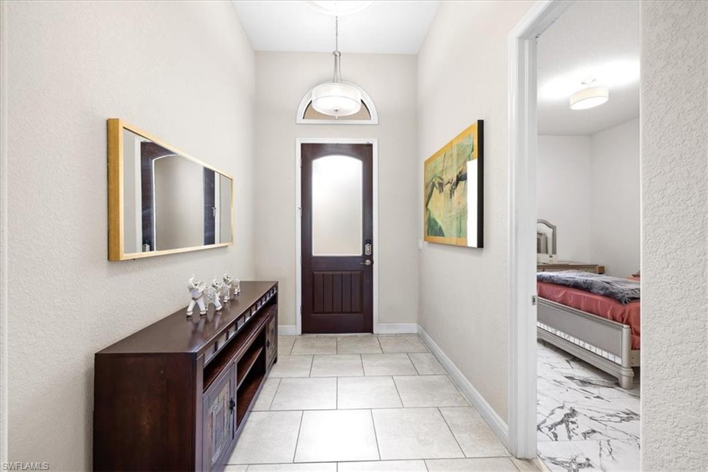 1509 Serrano Circle Naples, FL 34105 - Photo 2 of 24 a room with painting and a table