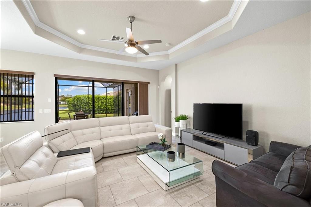 1509 Serrano Circle Naples, FL 34105 - Photo 6 of 24 a living room with furniture and a flat screen tv
