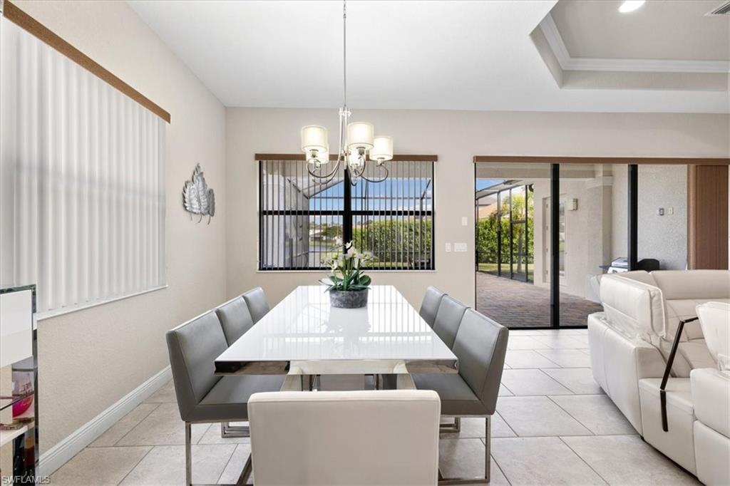 1509 Serrano Circle Naples, FL 34105 - Photo 10 of 24 a view of a dining room with furniture wooden floor and chandelier