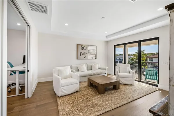 a view of a swimming pool with a bench and floor to ceiling window