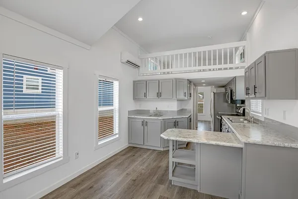 a kitchen with sink cabinets and wooden floor